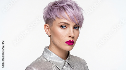 Beautiful young woman with trendy lavender pixie cut and bold magenta lipstick