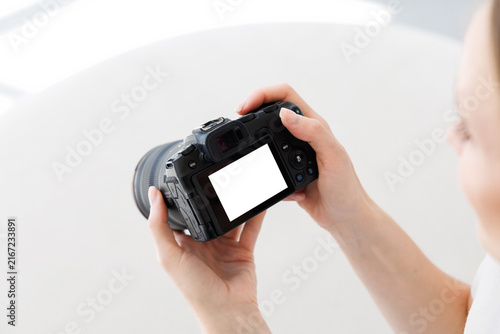 Fotografie Woman hands holding professional photo camera isolated