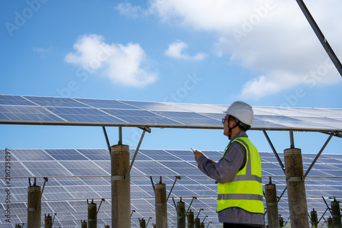 Worker inspecting solar power generation facilities outdoors