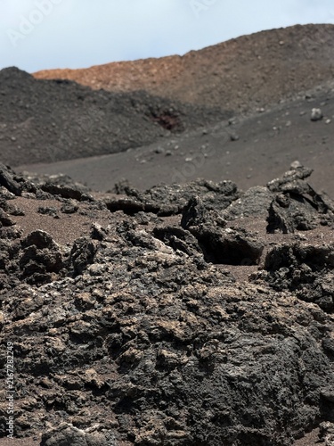 Yaiza, Spain - June 28, 2026: Volcanic rock surface displaying unique textures and colors, featuring shades of gray, pink, and brown in a natural environment