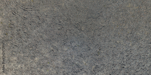 view from above on texture of gravel road among grass field
