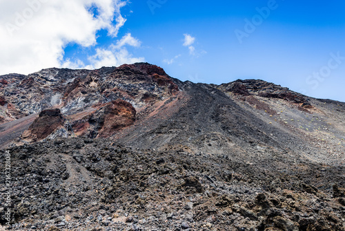 Dark volcanic slopes under blue sky in La Palma