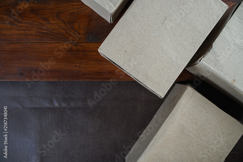 Plain cardboard boxes stacked on wooden board