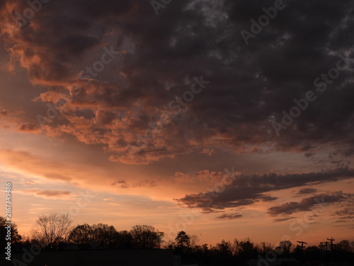 Canvas Print Broken orange clouds in the evening after sunset