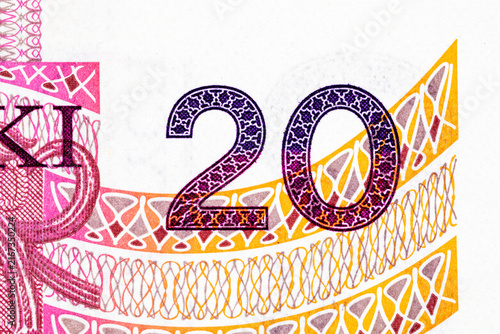 Fotografie Extreme macro close-up of the denomination number 20 and decorative guilloche patterns on a Polish 20 zloty banknote