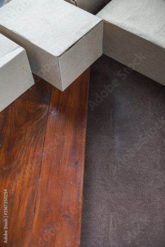 Plain cardboard boxes stacked on wooden board