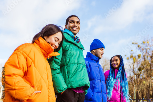 Multiracial group of young friends meeting outdoors in winter