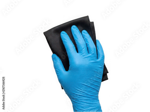 Blue gloved hand gripping black cloth for household cleaning