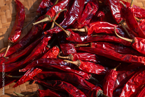 Dried chili peppers on traditional indonesian woven bamboo basket (besek), prepared to make sambal (spicy sauce), chili oil, or other hot dishes