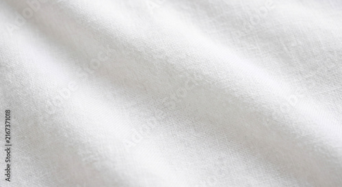 Close-up view of soft, white fabric with subtle texture, ideal for backgrounds or design projects. The natural feel and appearance provide a clean aesthetic.
