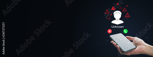 Cuadro en lienzo Unknown caller warning on smartphone with rejected and accepted call icons, hand holding mobile device against dark background with generous copy space