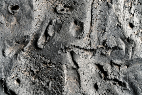 Dark gray rough wall texture with distressed concrete surface.