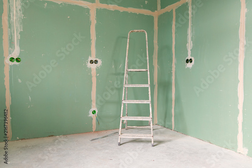 Konstfotografi Empty unfinished interior with renovation equipment and copy space