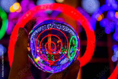 Crystal ball reflecting an illuminated Christmas tree