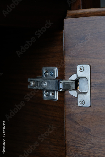 Canvas Print Close-up of concealed cabinet hinge installed on wooden furniture