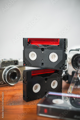 Vintage cassette tapes and camera on wooden desk