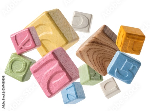 Colorful wooden alphabet blocks floating isolated on white background. Early childhood learning and education concept. Pastel toy letter cubes tumbling in studio light