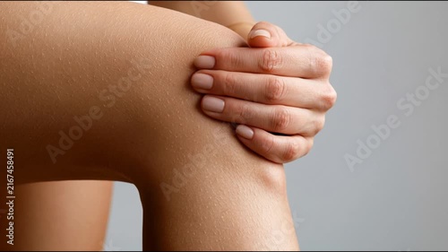 Close-up of Human Hand Gripping Knee During Joint Pain