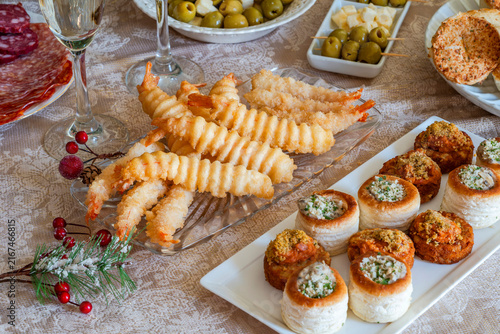 Christmas party, a selection of gourmet snacks and champagne set on a table. Selective focus