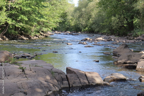 Panorama of a picturesque landscape in summer and the St-Charles river in Wendake in Quebec city. Beautiful stream of the river with trees and waterfalls. Protection of the water and environment.