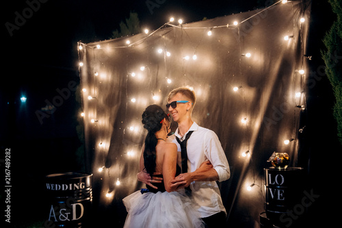 Fotografie A dance of a young, unusual, freaky newlywed couple against