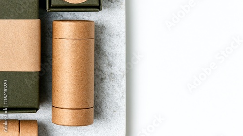 Kraft Paper Tube and Dark Green Boxes on Stone Surface