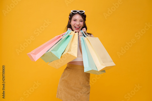 Shopping woman holding colorful bags and smiling expressing retail therapy consumer happiness shopping spree seasonal sale purchasing confidence fashion lifestyle and customer experience.