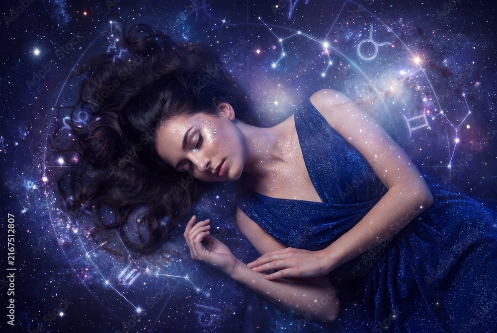 Obraz premium A mystical young woman sleeping peacefully amidst glowing zodiac constellations inside a magical starry galaxy.