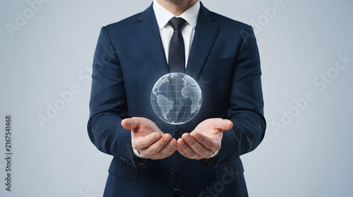 businessman holding globe for global business and international leadership