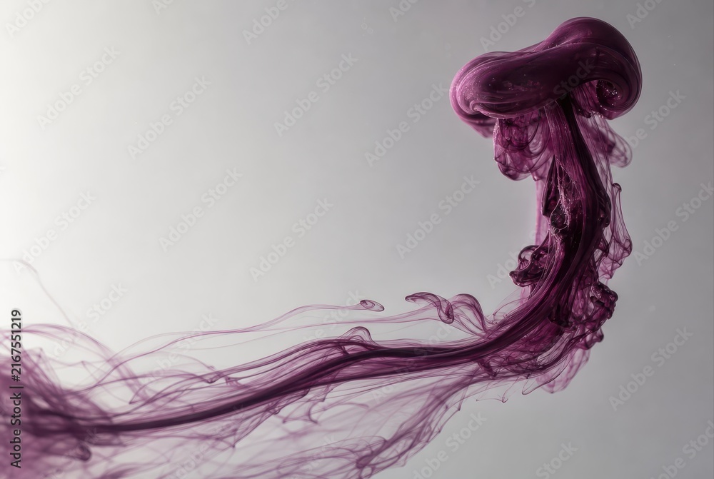 Fototapeta premium Purple ink plume swirling in water on a soft gray background