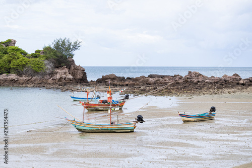 Obraz na plátne Fishing boats resting in shallow coastal bay at low tide