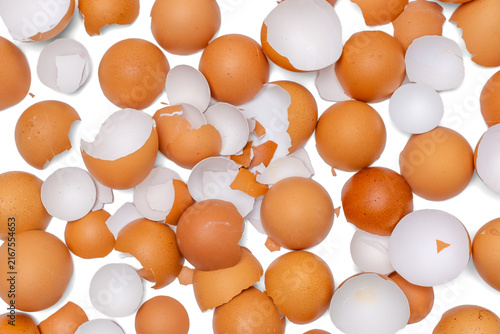 Konstfotografi Full frame background of cracked brown chicken eggshell pieces scattered on white surface