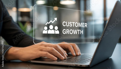 Professional person typing on laptop computer showing virtual holographic interface for tracking business customer growth metrics
