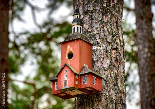 Birdhouse shaped likethe church of Habo mounted on a tree at filmbyn Smaland near Mariannelund, Sweden