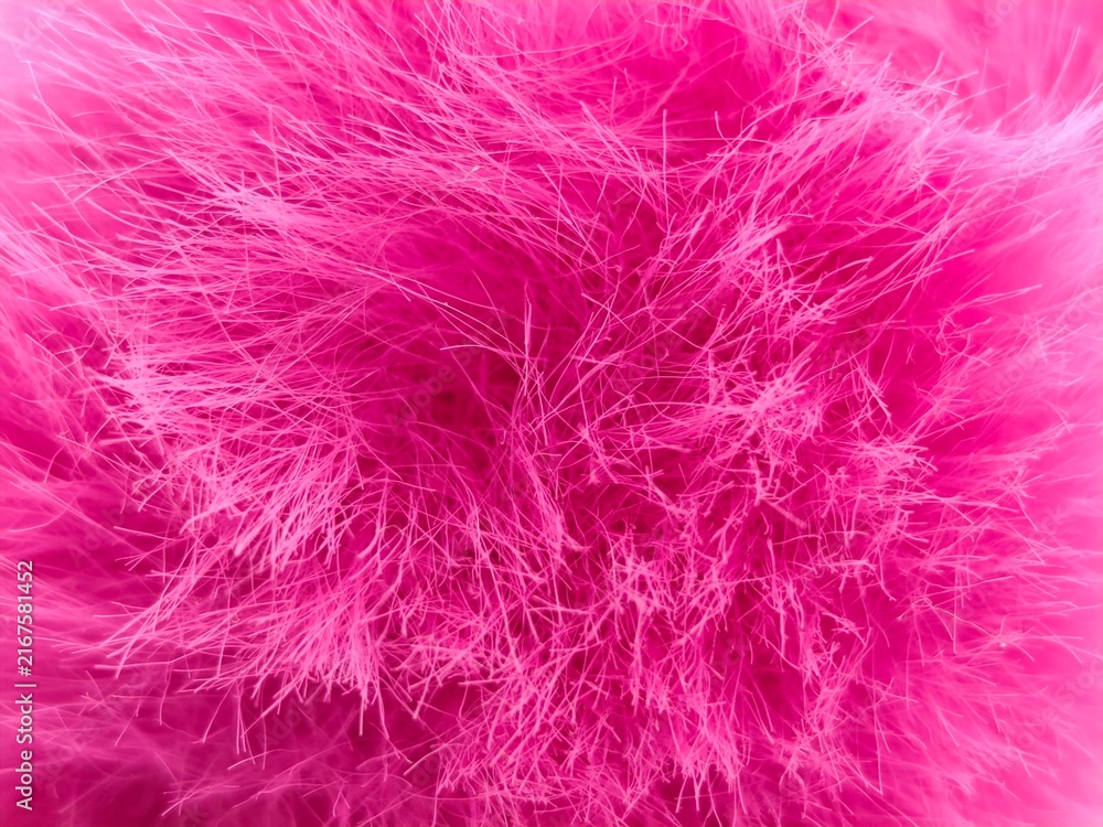 Obraz premium Background view of vibrant hot pink faux fur featuring soft, densely packed fuchsia fibers and a rich neon magenta tone, creating a luxurious, cozy abstract plush texture.
