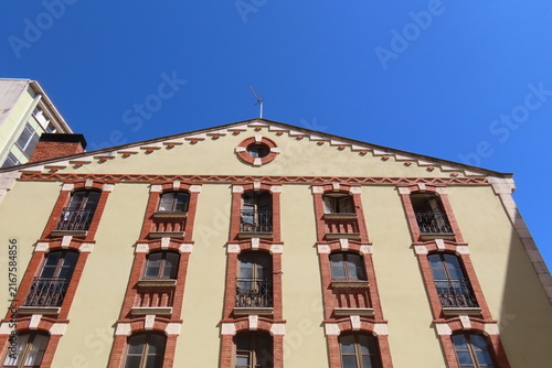 Old Building Facade with Balconies and Red Shutters
