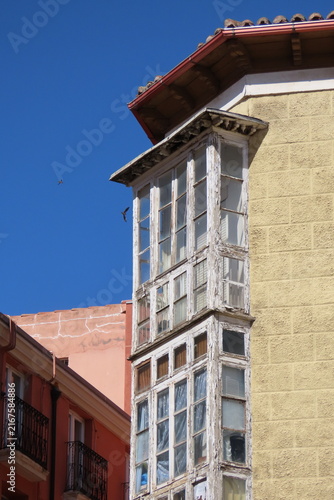 Glazed Corner Bay Window on Old Building with Yellow Facade