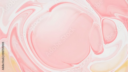 Abstract pink liquid marble background with soft flowing paint swirls and fluid texture.