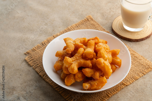 Deep fried dough stick,Chinese cruller or Chinese doughnut in white plate.It is popularly eaten for breakfast.
