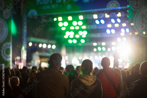 A concert on the street in the city with a large number of people.