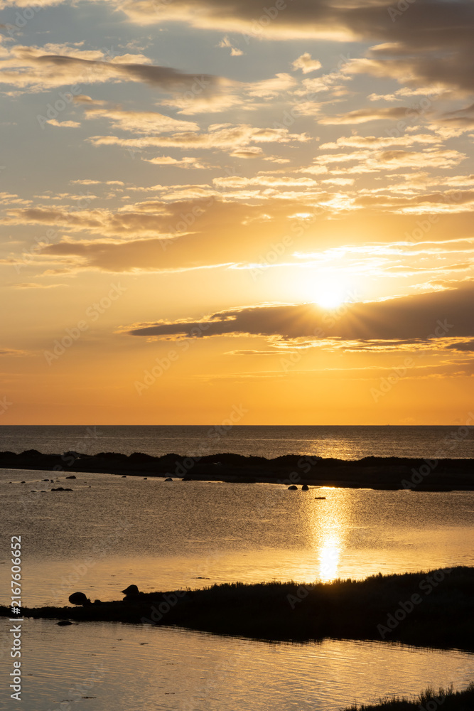 Obraz premium Golden hour at the Besser Rev with sunrays and dramatic sky, Samsoe, Denmark