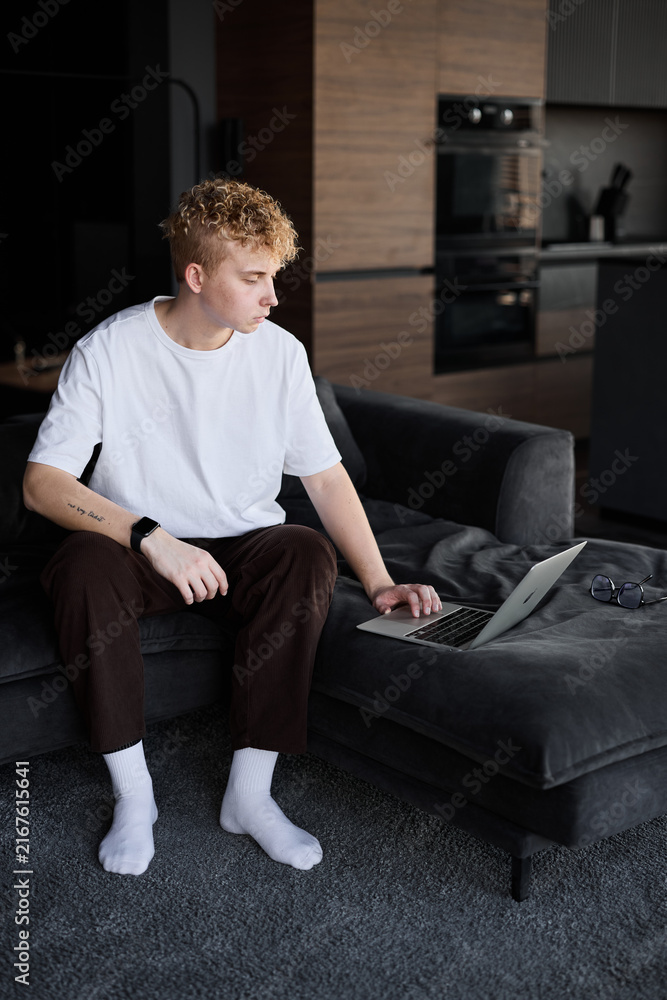 Fototapeta premium Thoughtful caucasian man planning day in modern kitchen lounge