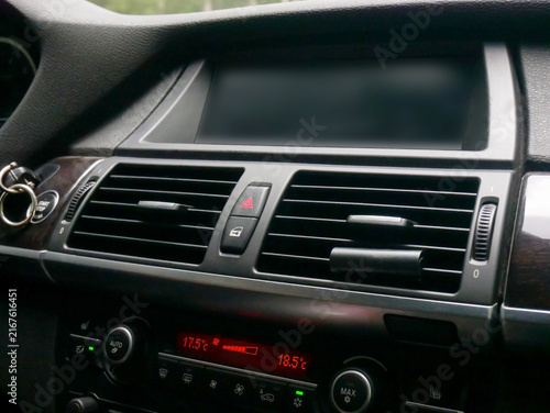 Car dashboard with digital climate control and air vents