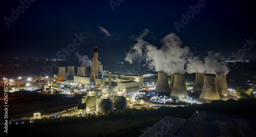 Drax Power Station, North Yorkshire, England, aerial view of the illuminated energy plant, cooling towers and emissions from electricity generation.