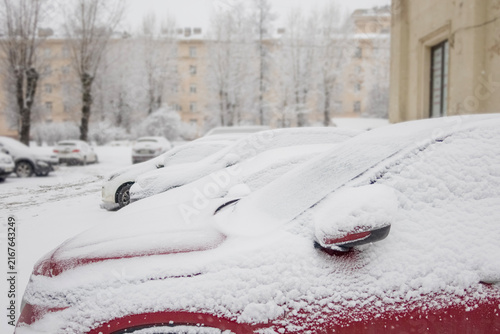 parked cars covered in snow after a snowfall