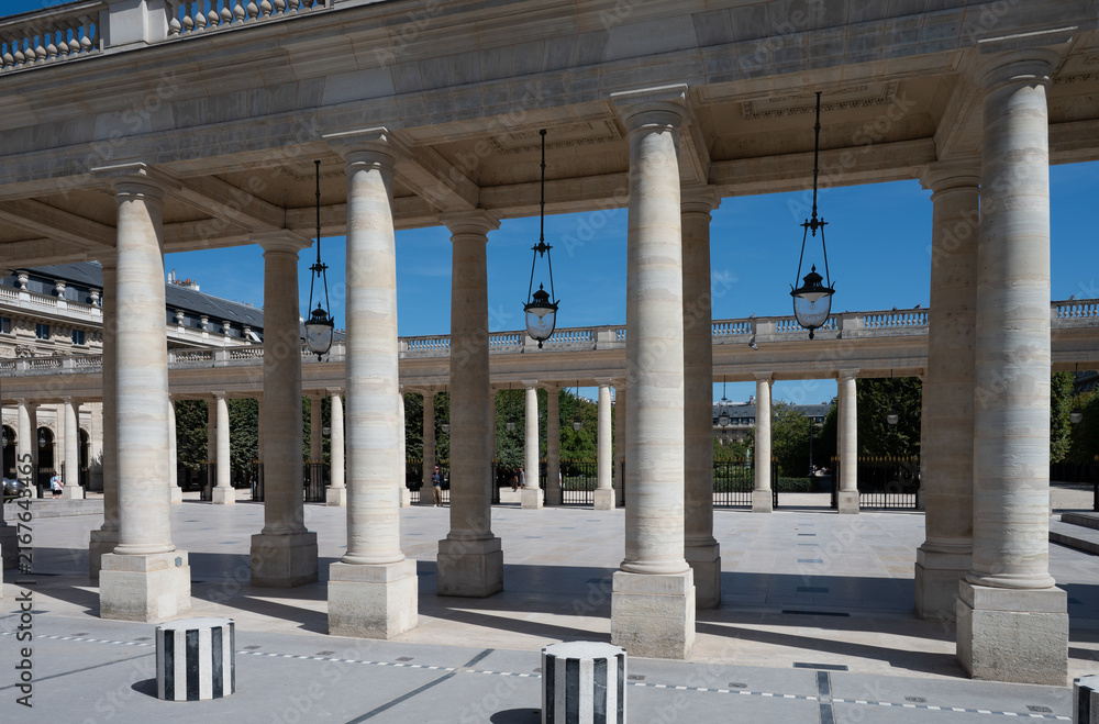 Fototapeta premium Columns and inner courtyard of the Palais Royal in Paris, France, on a sunny summer day