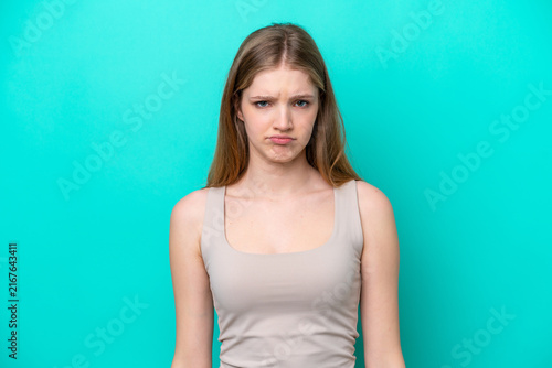 Teenager Russian girl isolated on blue background with sad expression
