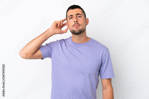 Bild auf Leinwand Young handsome caucasian man isolated on white background having doubts