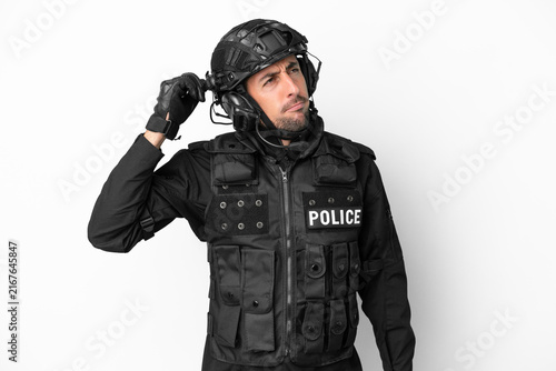 Фотография SWAT caucasian man isolated on white background having doubts and with confuse f