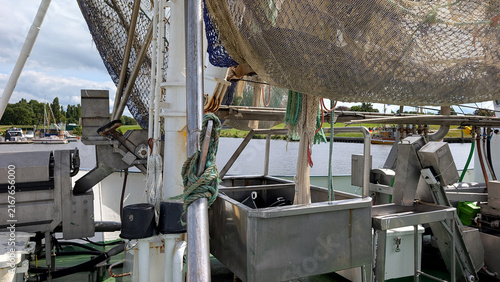 Принти на полотні Fishing vessel deck with nets and processing equipment.